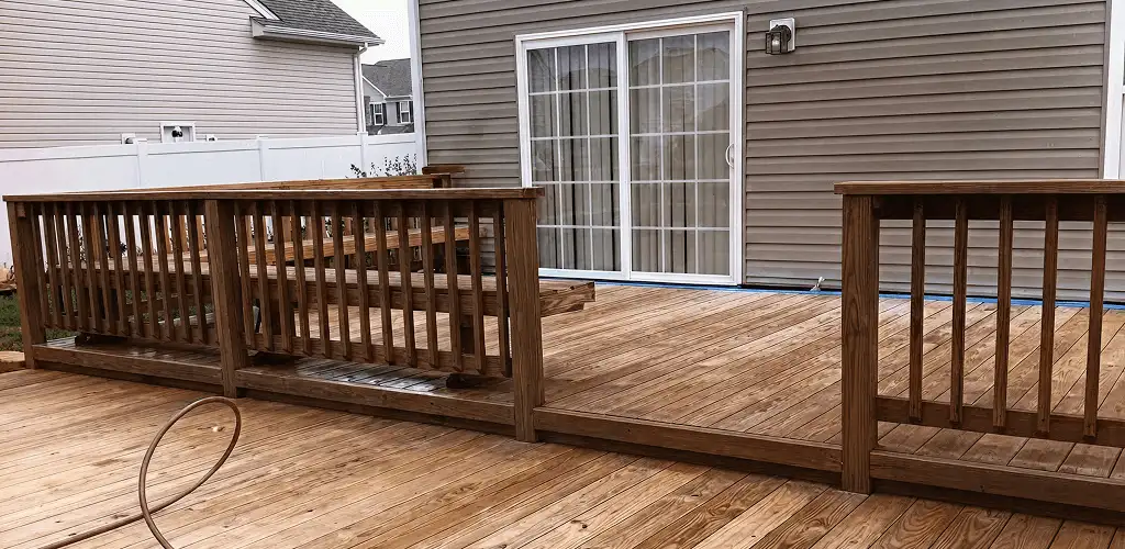 Deck sealing service protecting a backyard wood deck and railings in Fort Lauderdale, FL