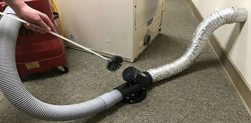 Dryer vent cleaning service removing lint from a dryer duct connection in Fort Lauderdale, FL