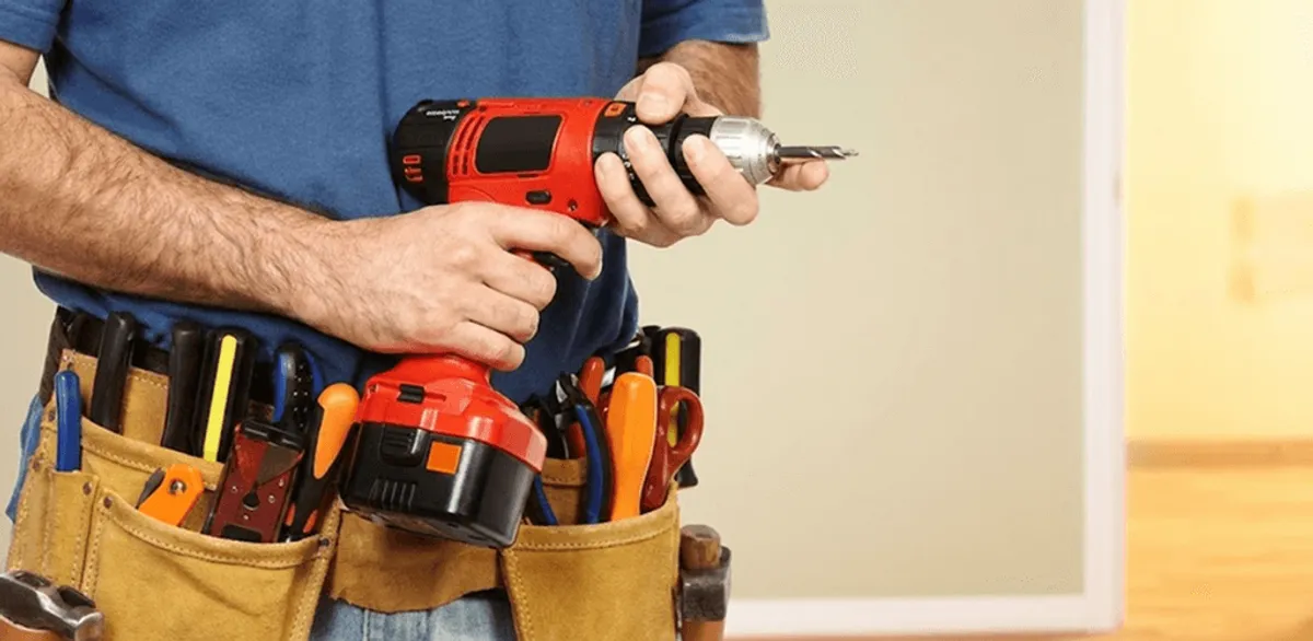 Handyman holding a power drill for home repairs and installations in Fort Lauderdale, FL