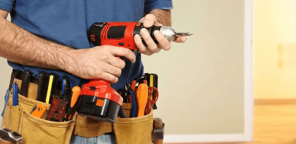 Handyman holding a power drill for home repairs and installations in Fort Lauderdale, FL